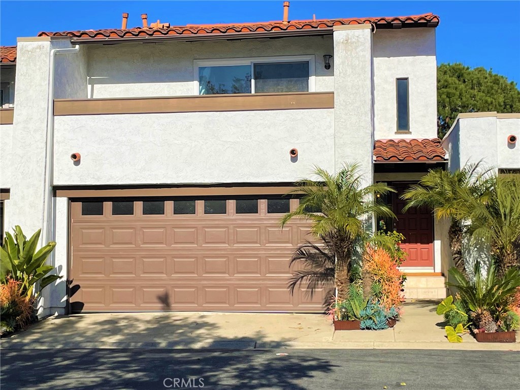 a front view of a house with plants