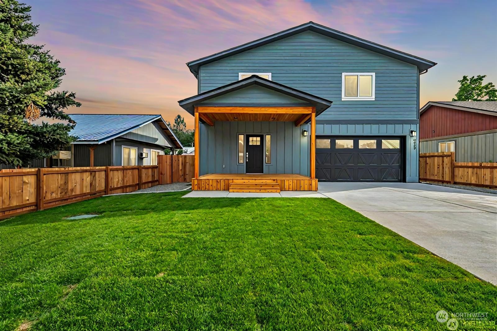 a front view of a house with yard and green space