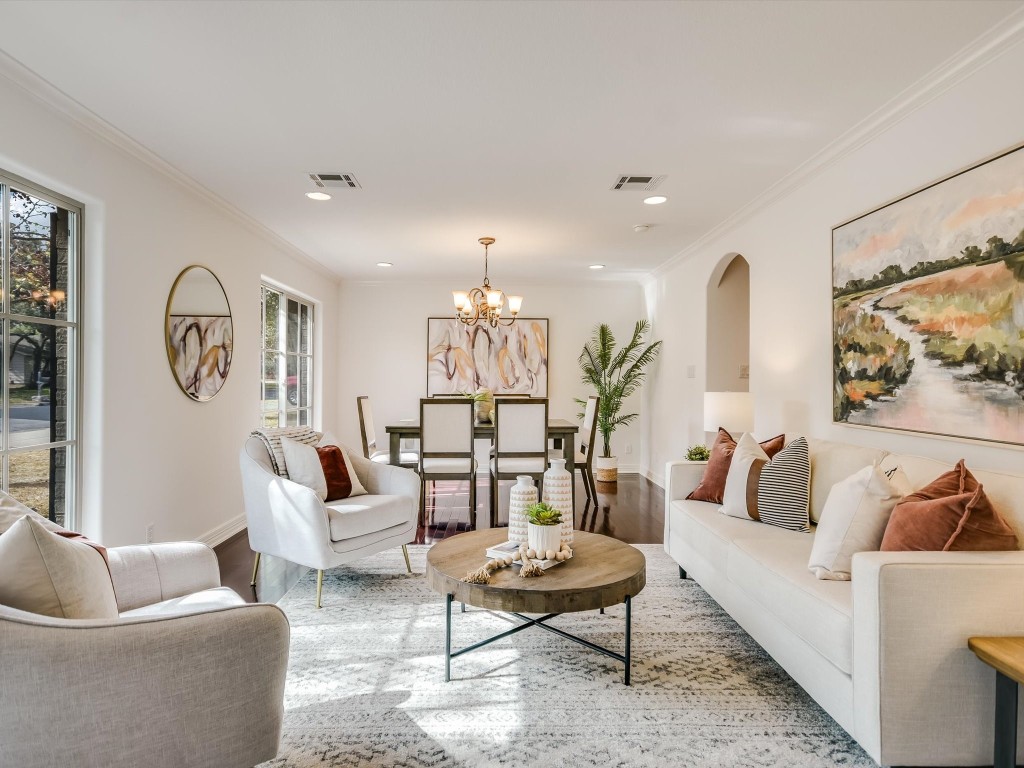 a living room with furniture and a potted plant