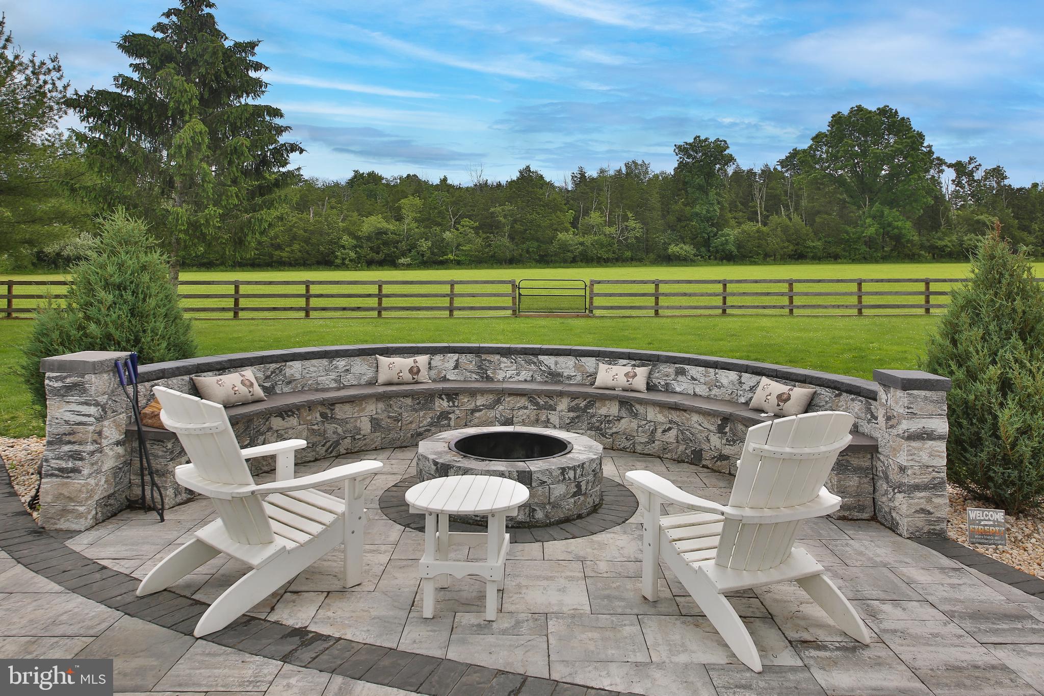 a view of a chairs and table in backyard