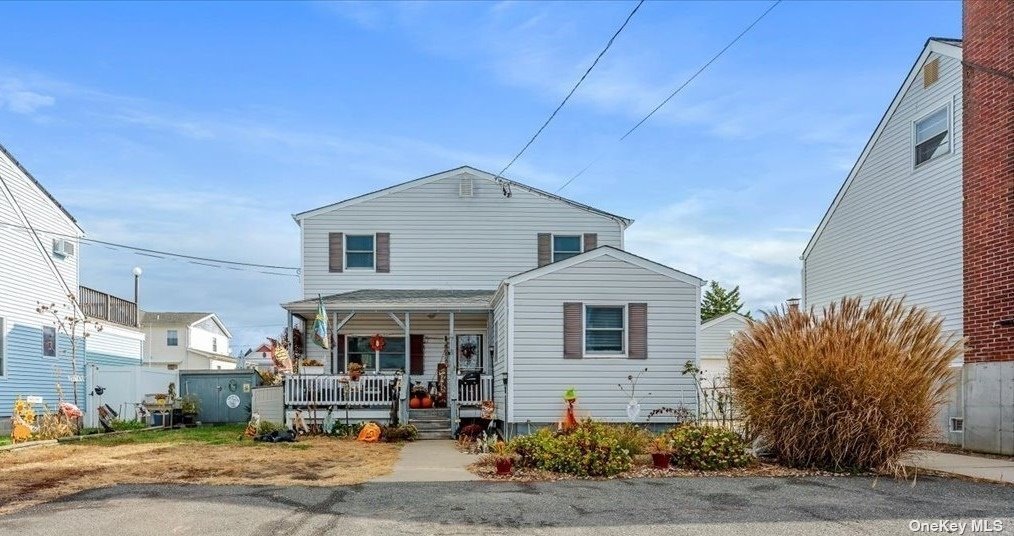 a front view of a house with sitting area