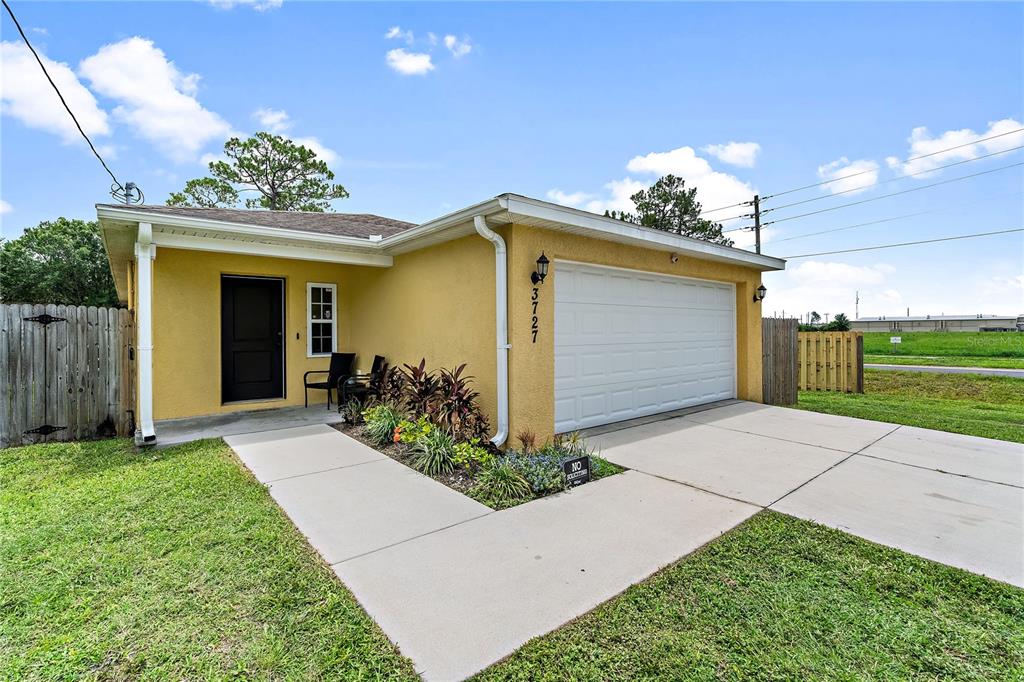 a front view of a house with a yard and a garage