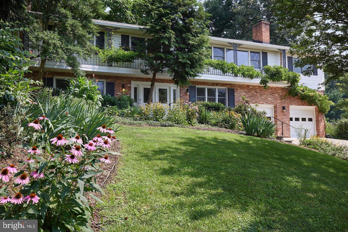 a front view of house with yard and trees