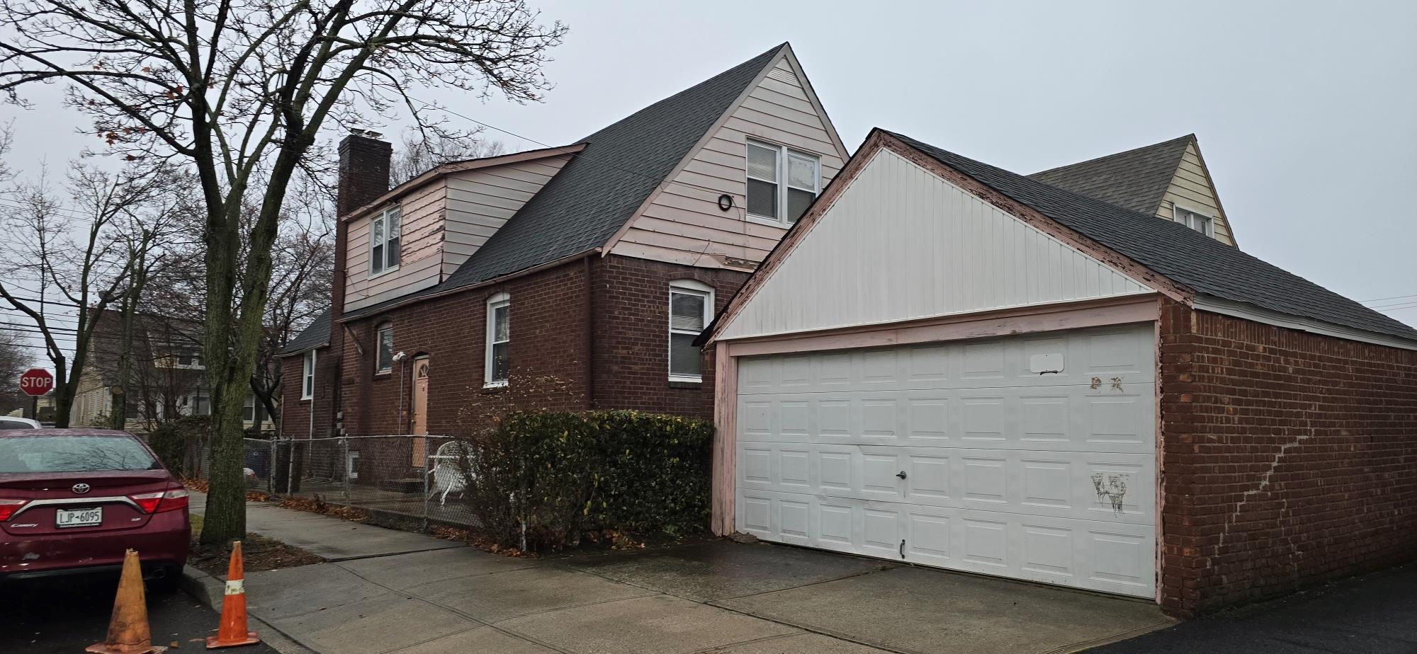 View of side of home with an outbuilding and a garage