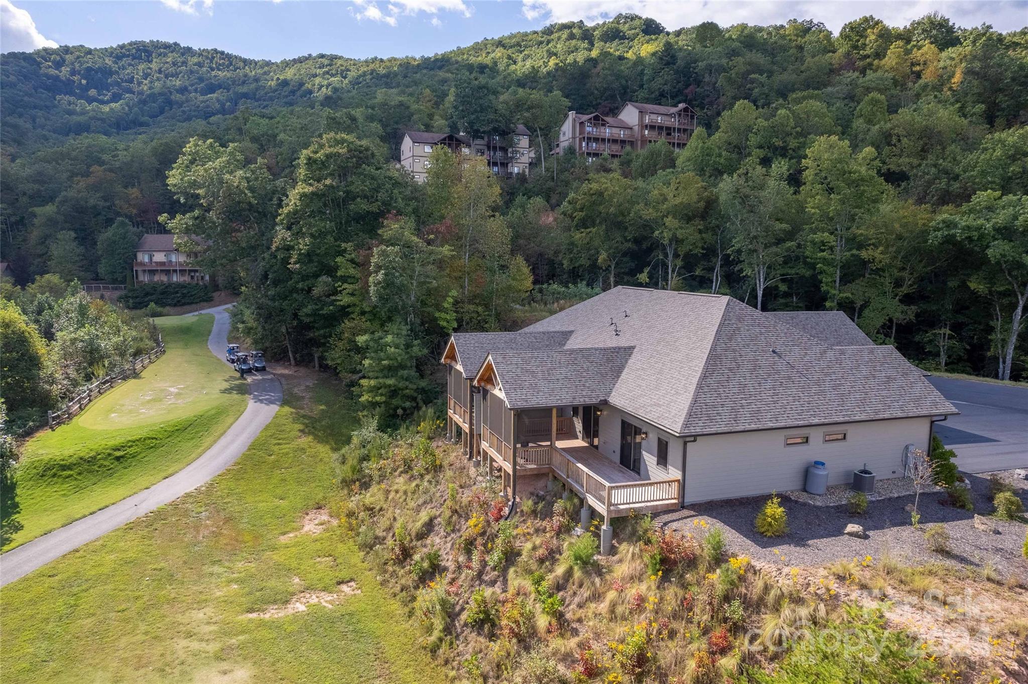 an aerial view of a house with big yard