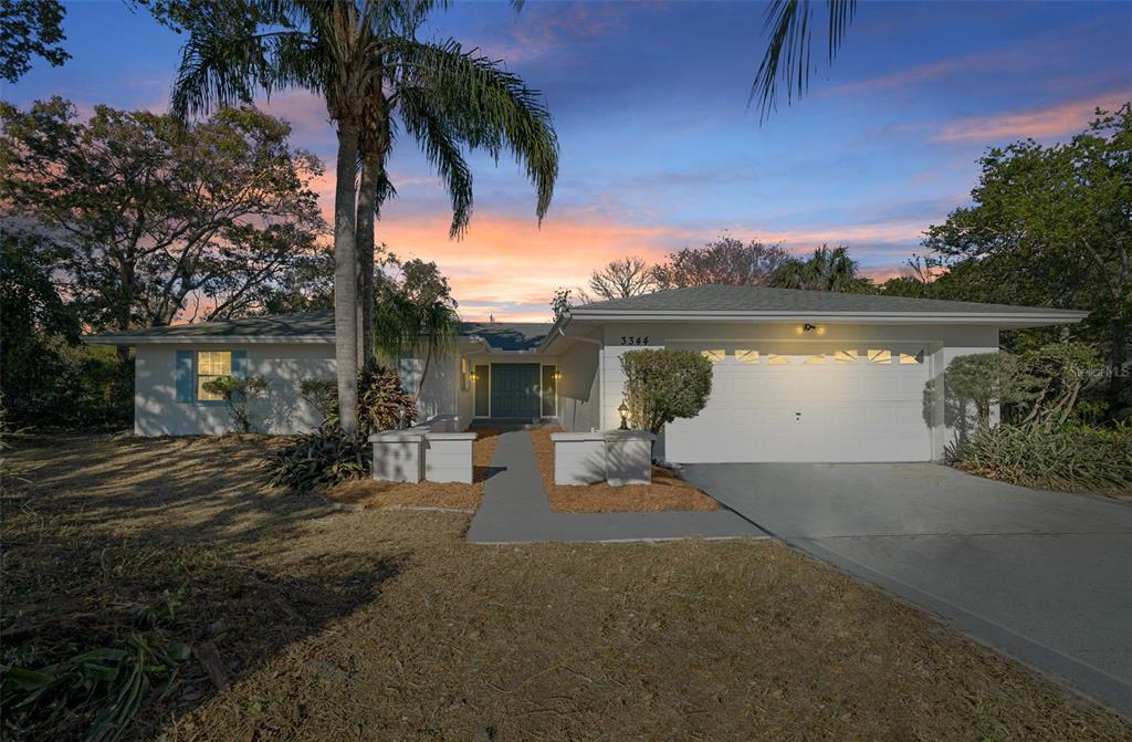 a view of a house with outdoor space and a lake view