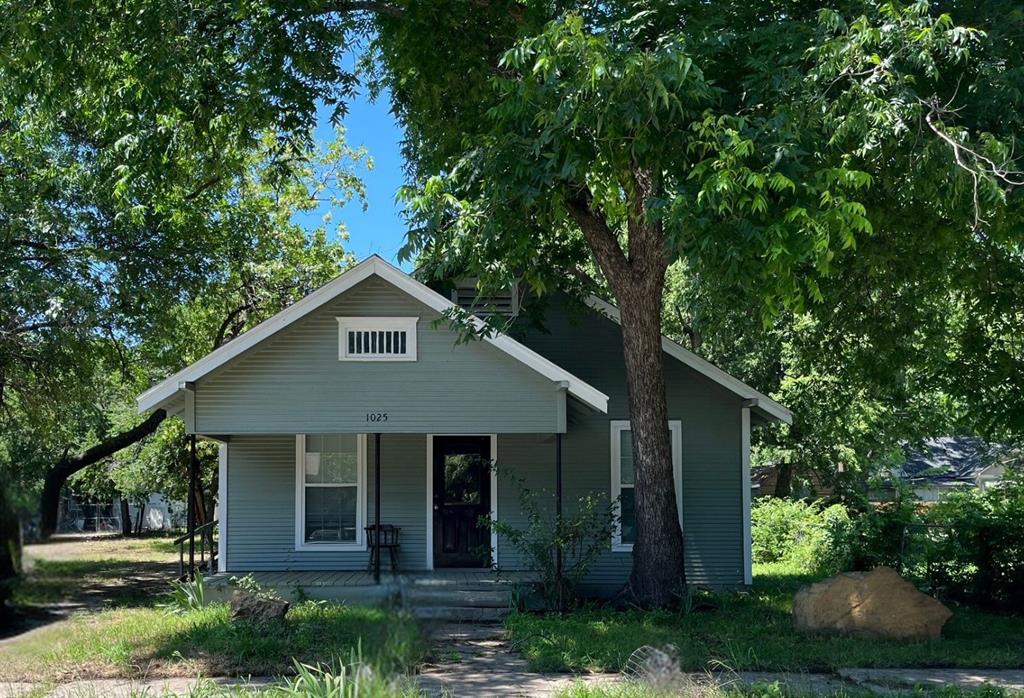 a house with a tree in front of it