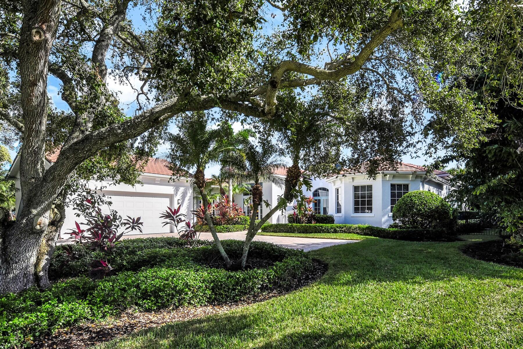 a front view of a house with a yard and trees