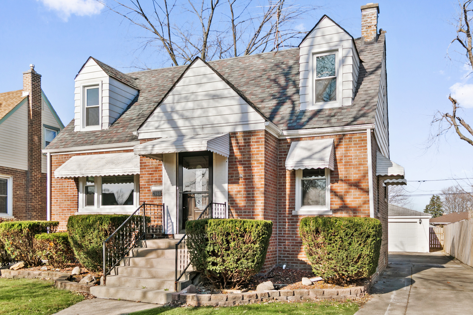 a view of a brick house with large windows