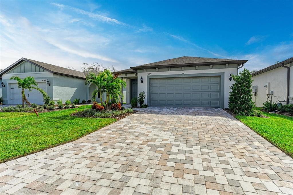 a front view of a house with a yard and garage