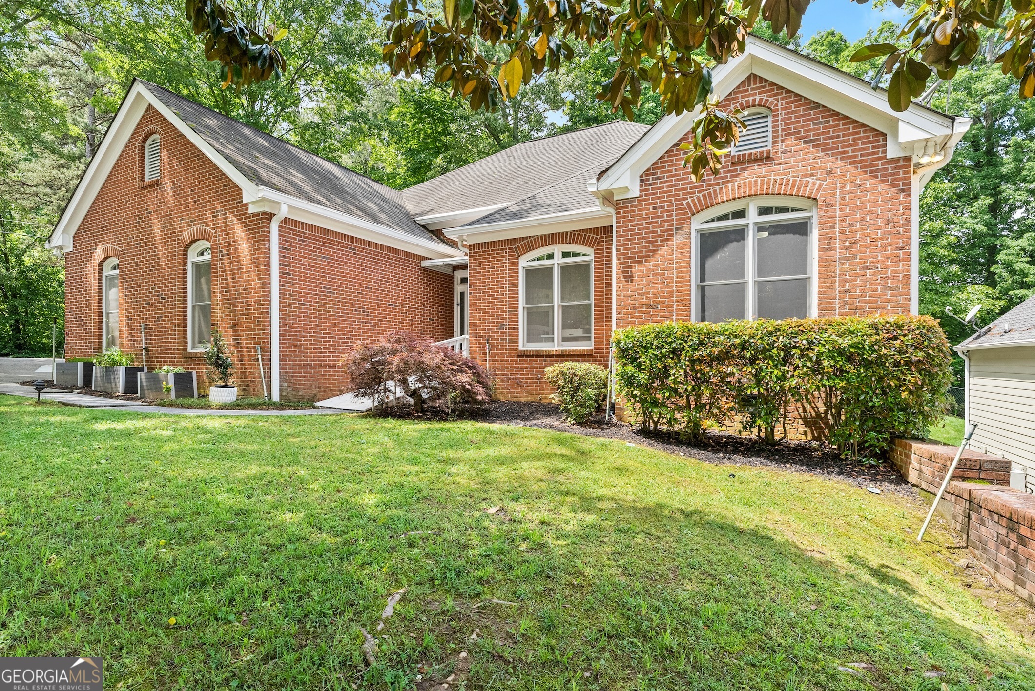 a front view of a house with garden