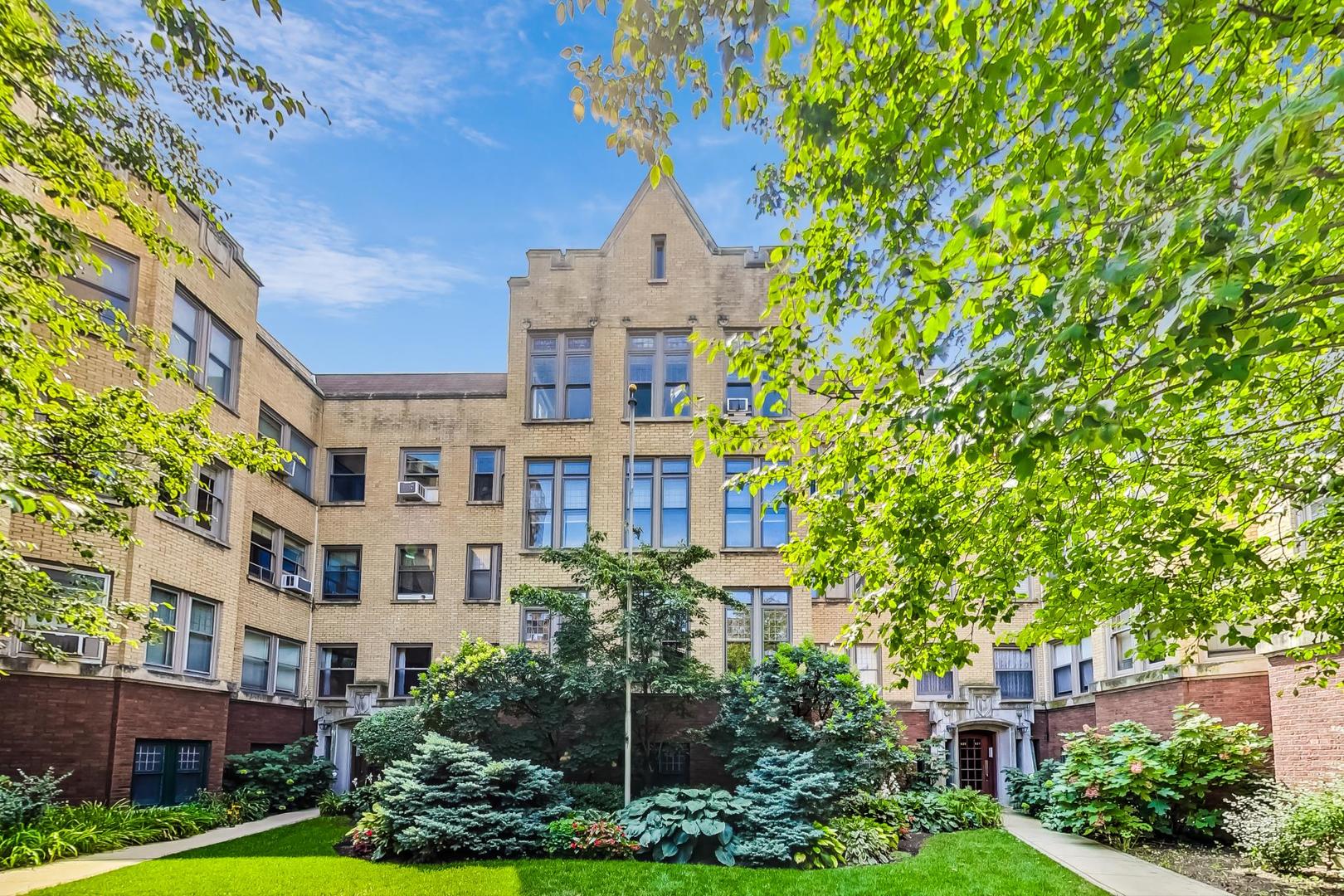 a view of building with yard in front of it