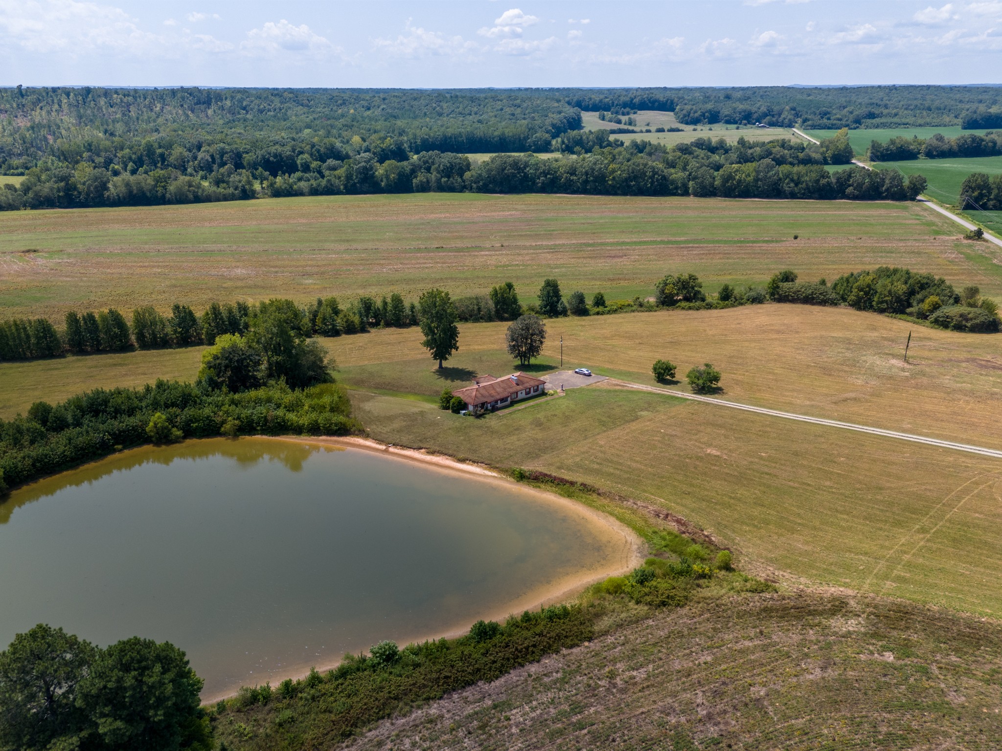 an aerial view of a house with a yard and lake view