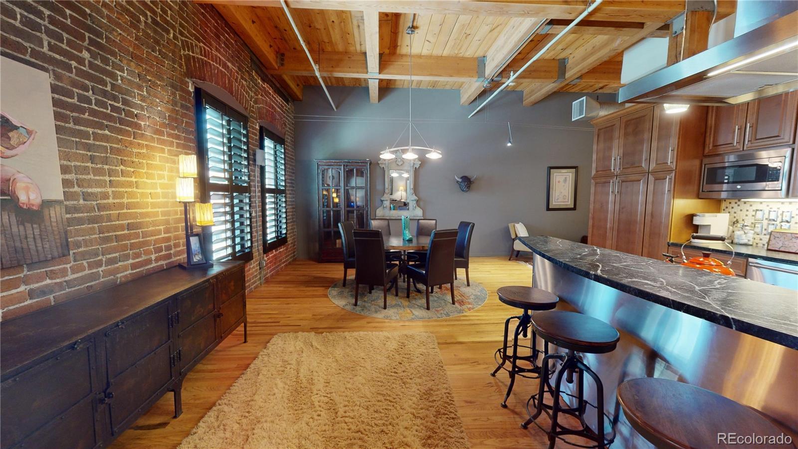 a dining room with furniture and a large window