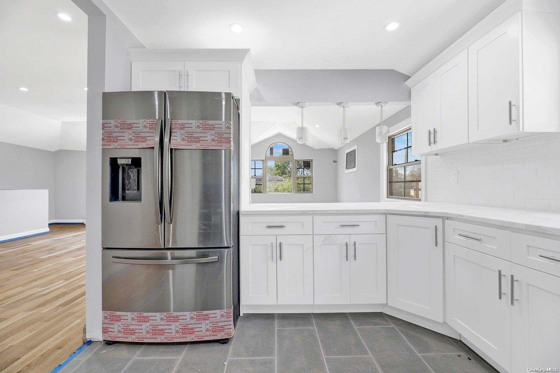 a kitchen with cabinets and stainless steel appliances