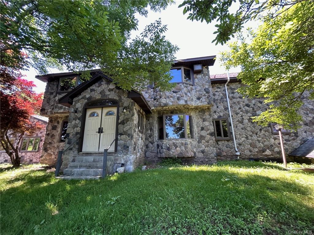 a front view of a house with a garden