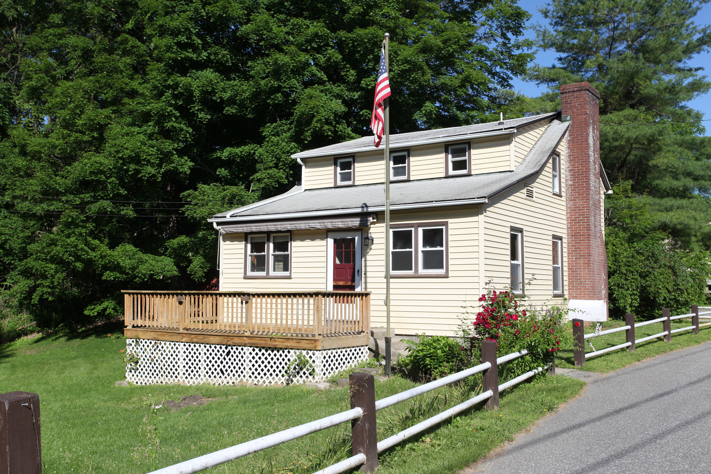 a side view of a house with a yard