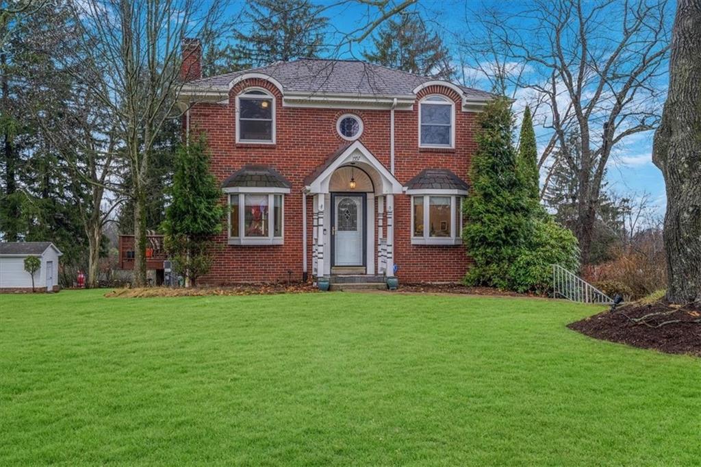 a front view of a house with a garden