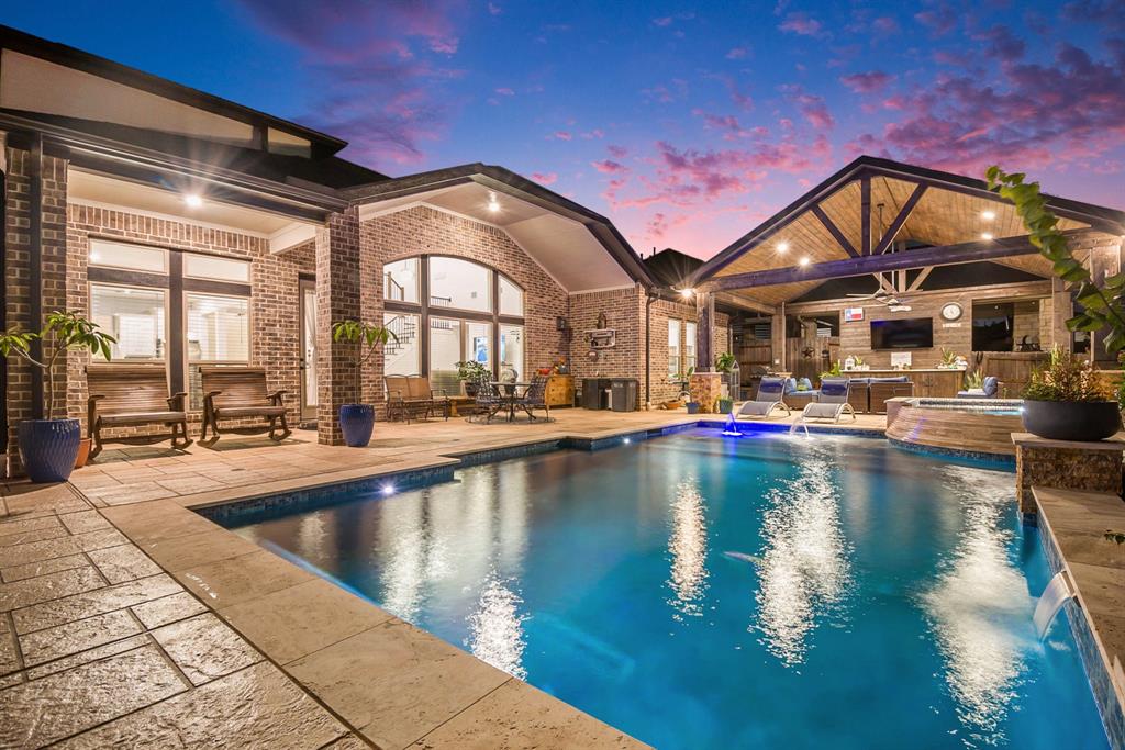 a view of a swimming pool with outdoor seating