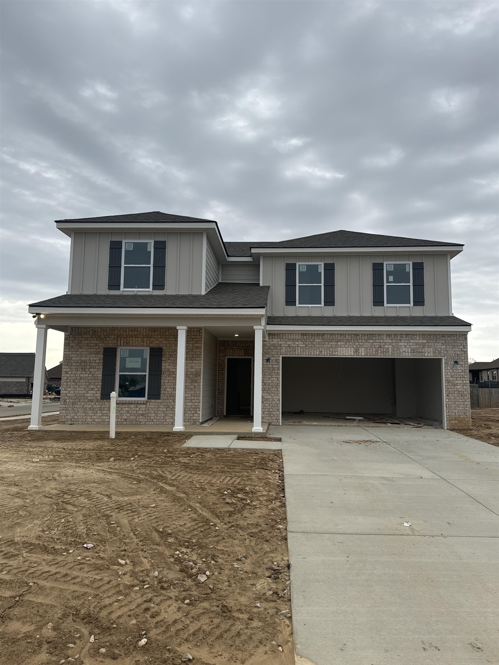 View of front of house featuring covered porch and a garage