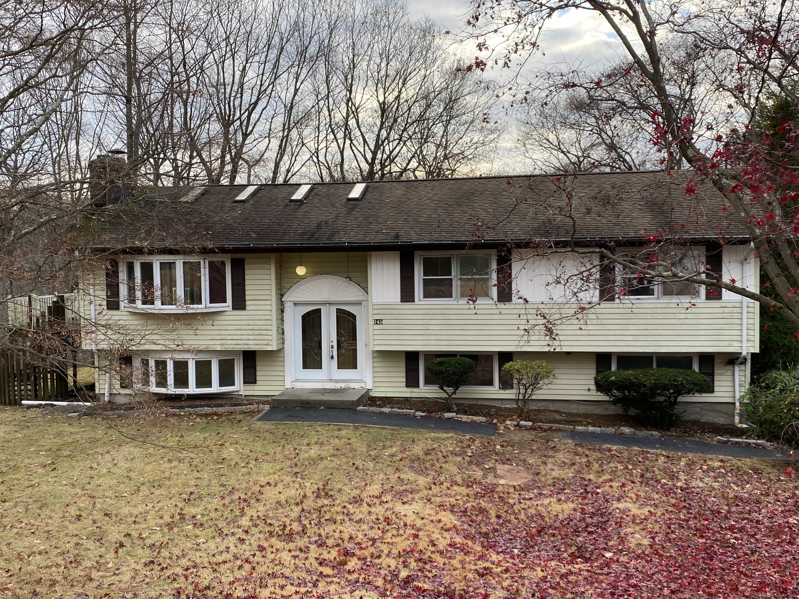 a front view of a house with a garden