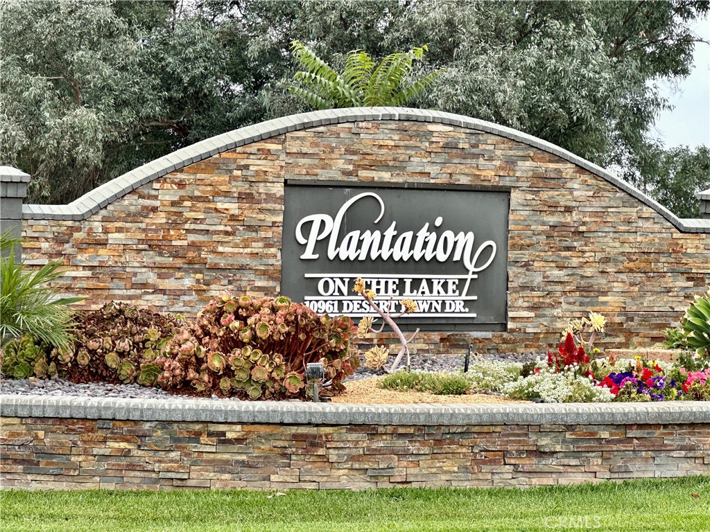 a view of sign board with flower around