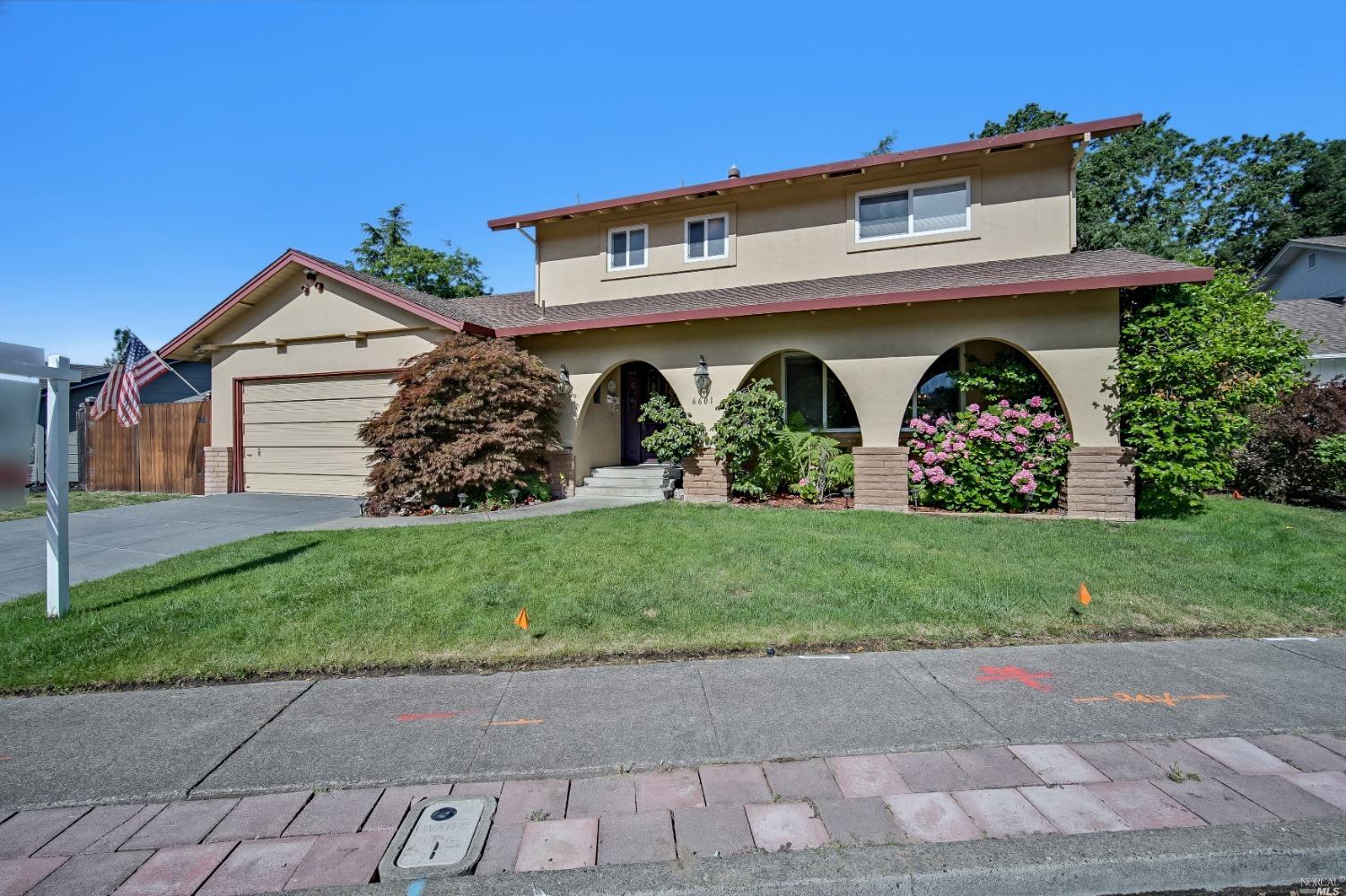 a front view of house with garden and entertaining space