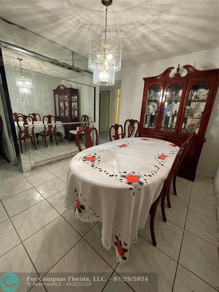 a view of a dining room with furniture and a chandelier