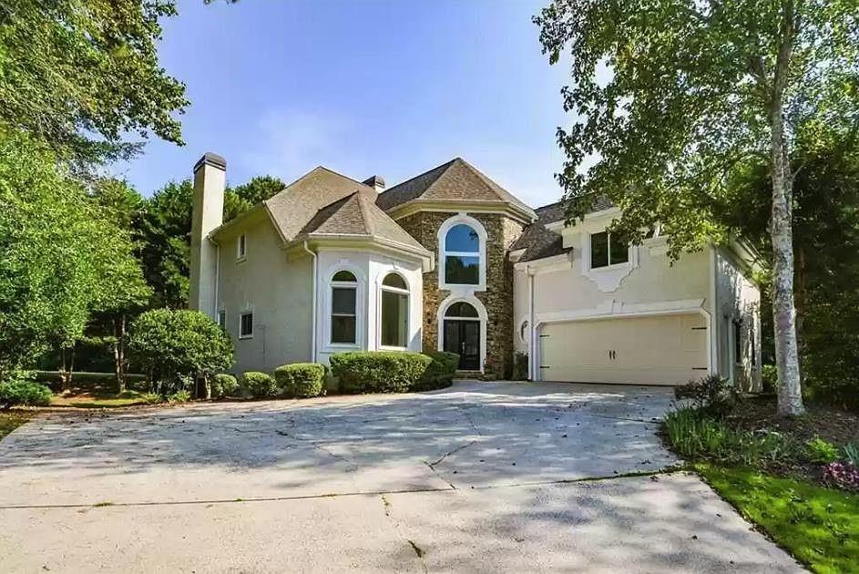 a front view of a house with garden