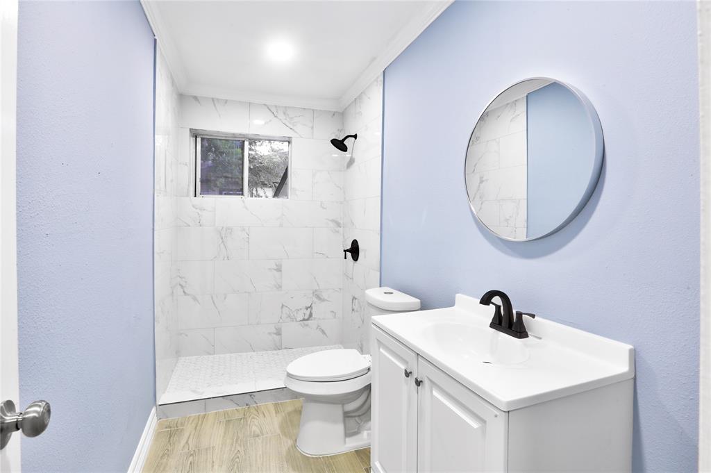 a bathroom with a toilet a sink and mirror