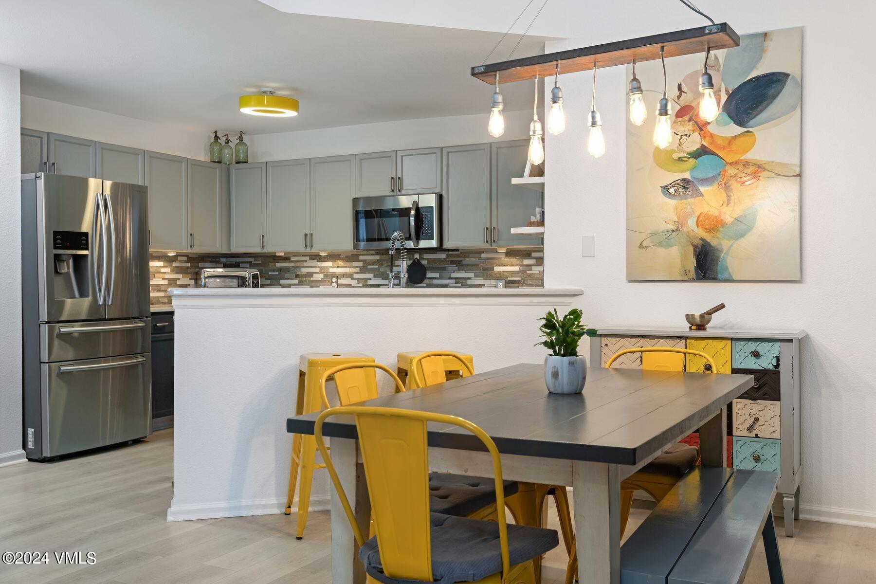 a kitchen with stainless steel appliances granite countertop a sink and a refrigerator