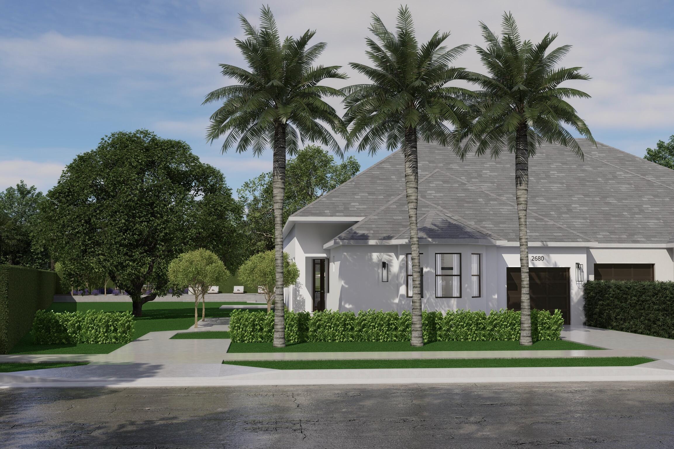 front view of house with a yard and palm trees