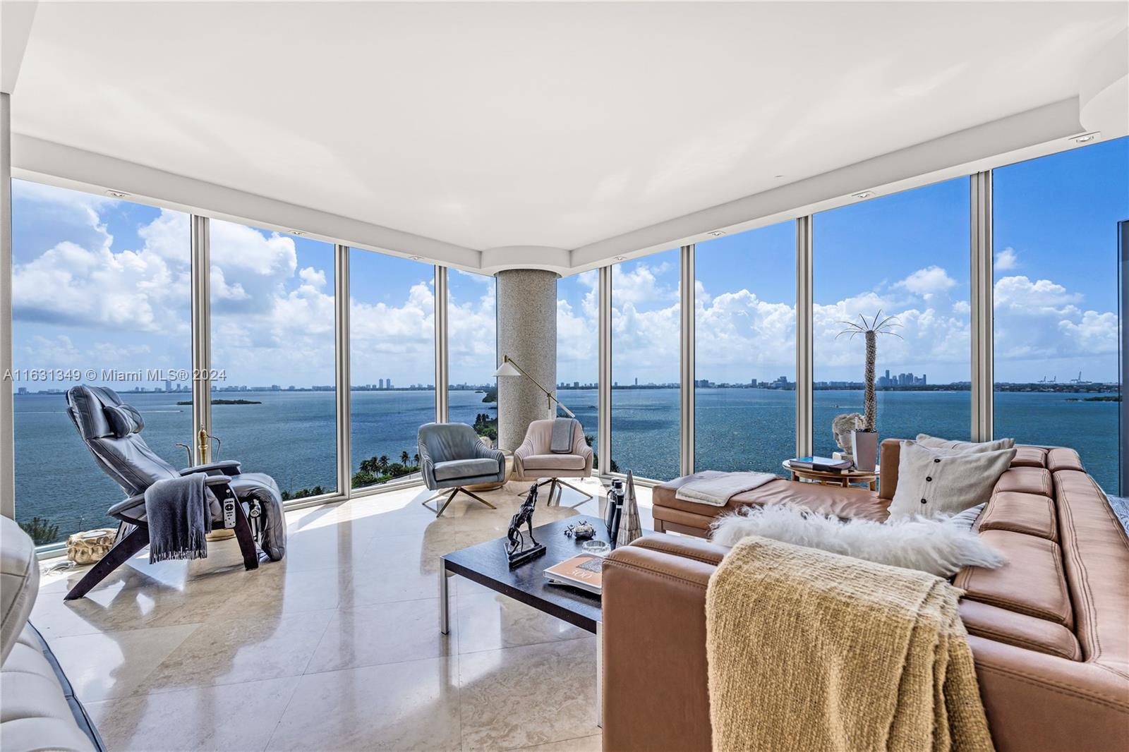 a living room with furniture and a floor to ceiling window