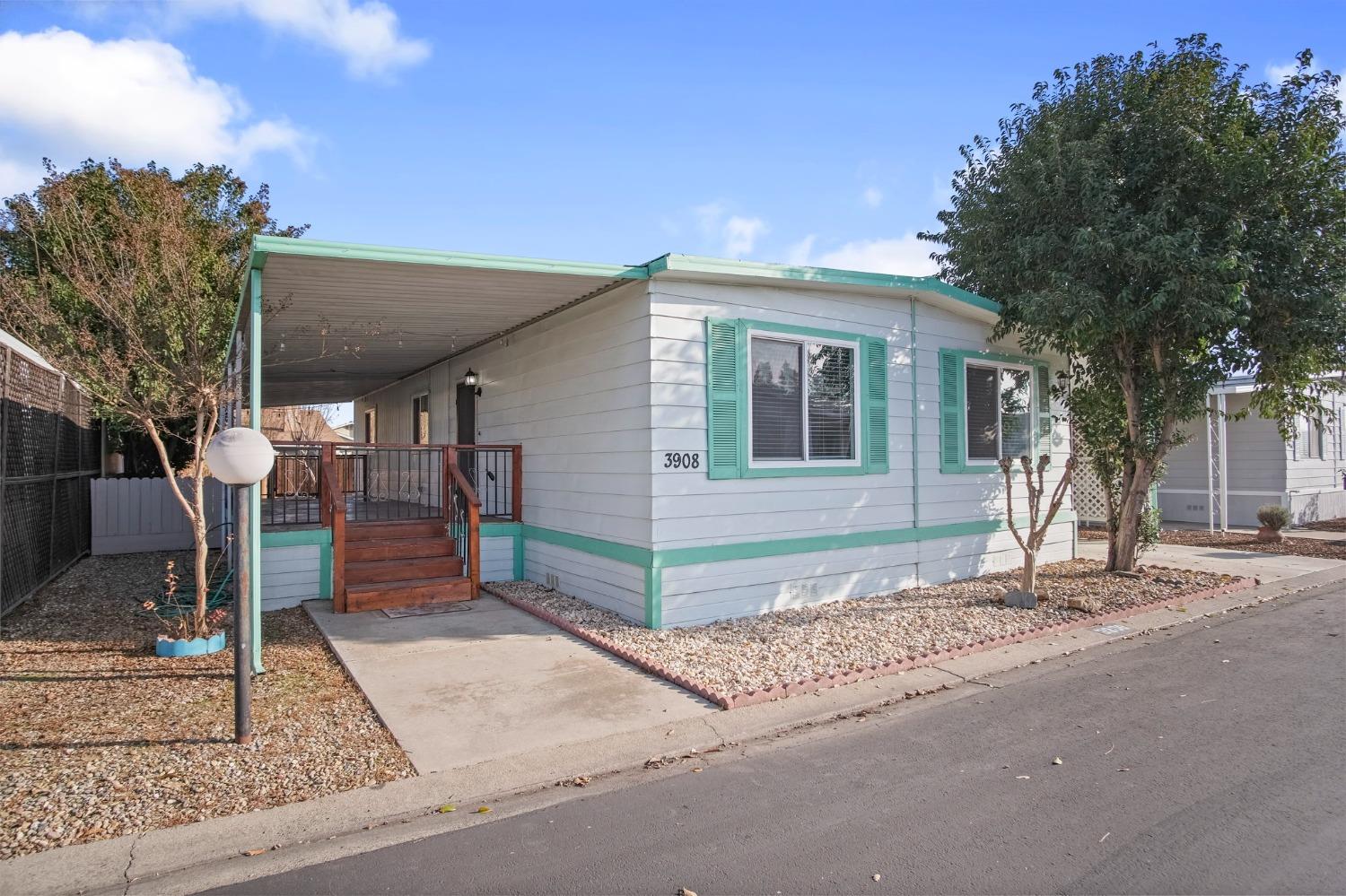 a front view of a house with a tree