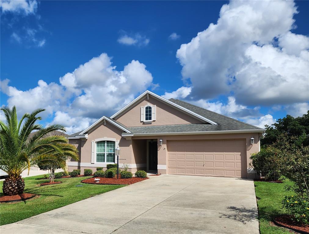 a front view of a house with a yard and garage