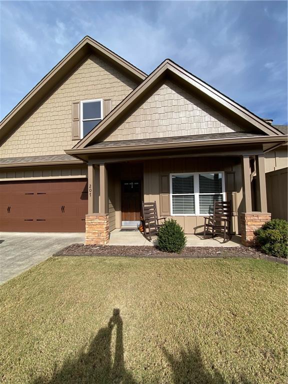 a front view of a house with a yard