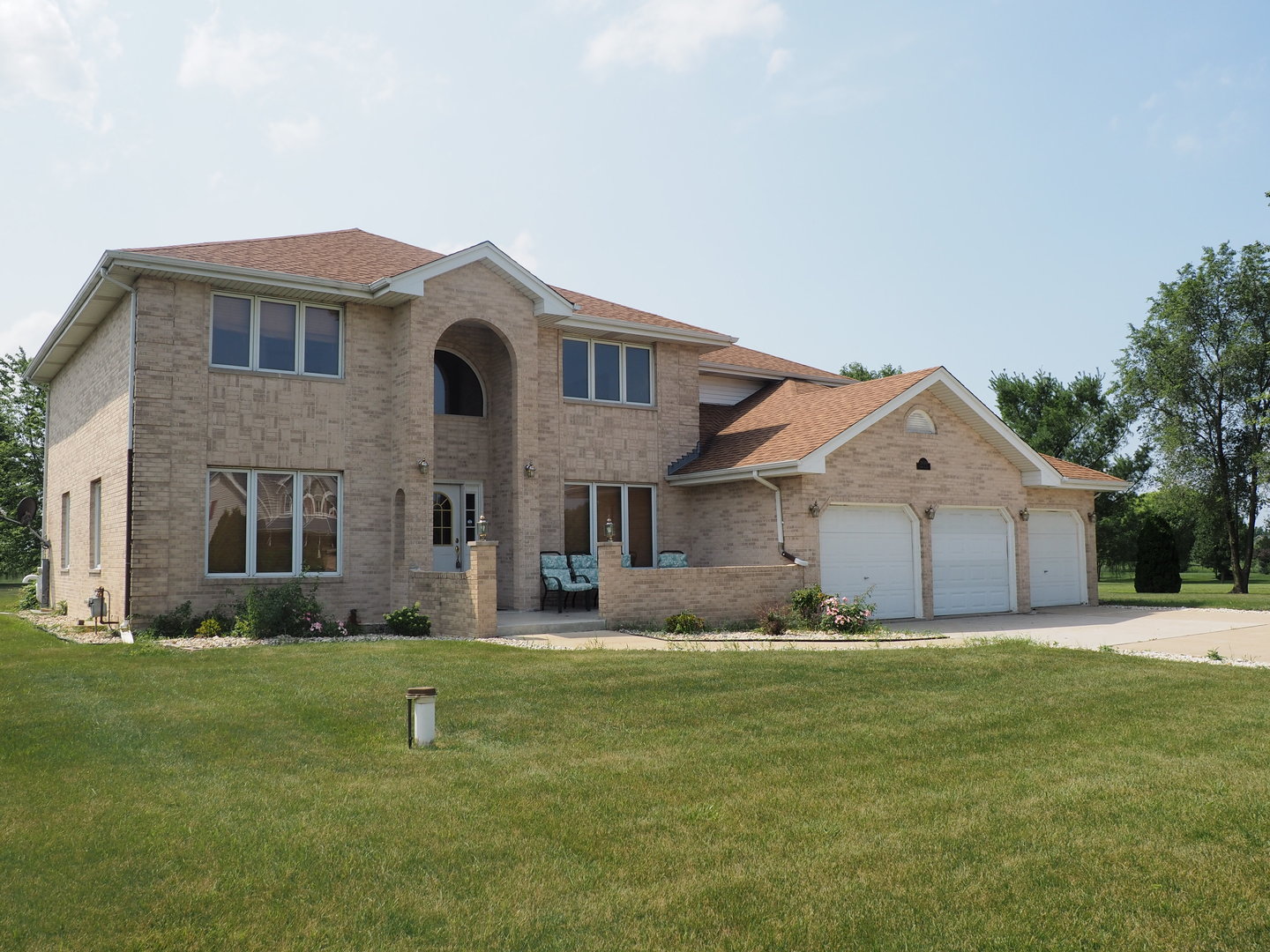 a front view of house with yard and trees