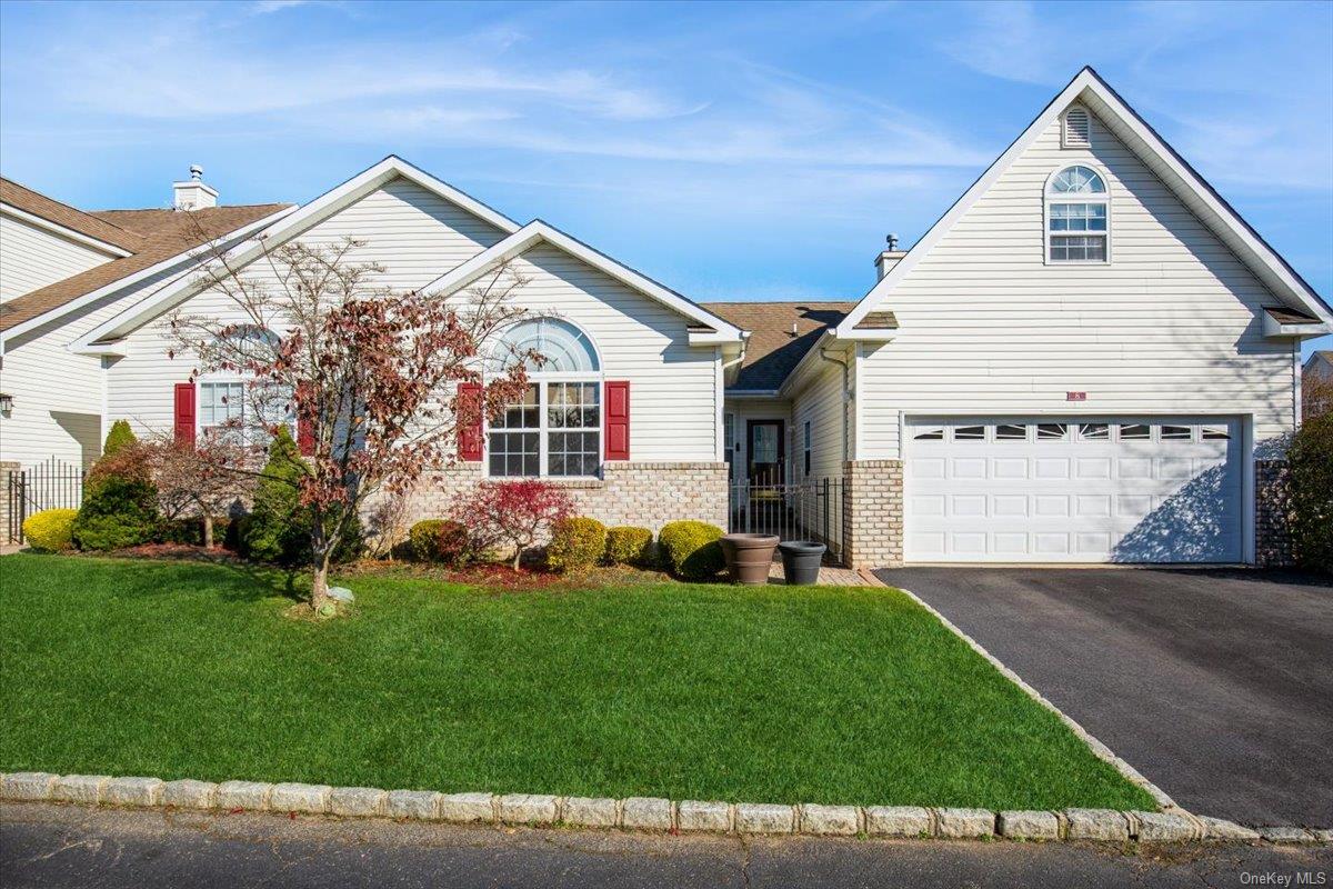 View of front of home featuring a front yard and a two car garage