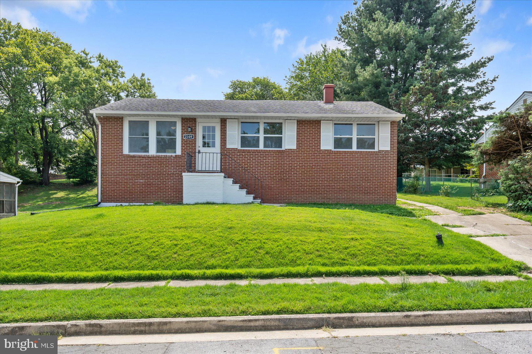 a front view of house with yard and green space