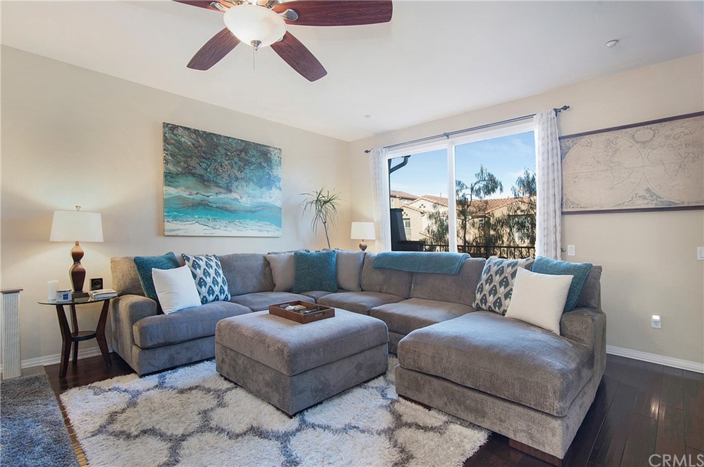 a living room with furniture and a painting on the wall