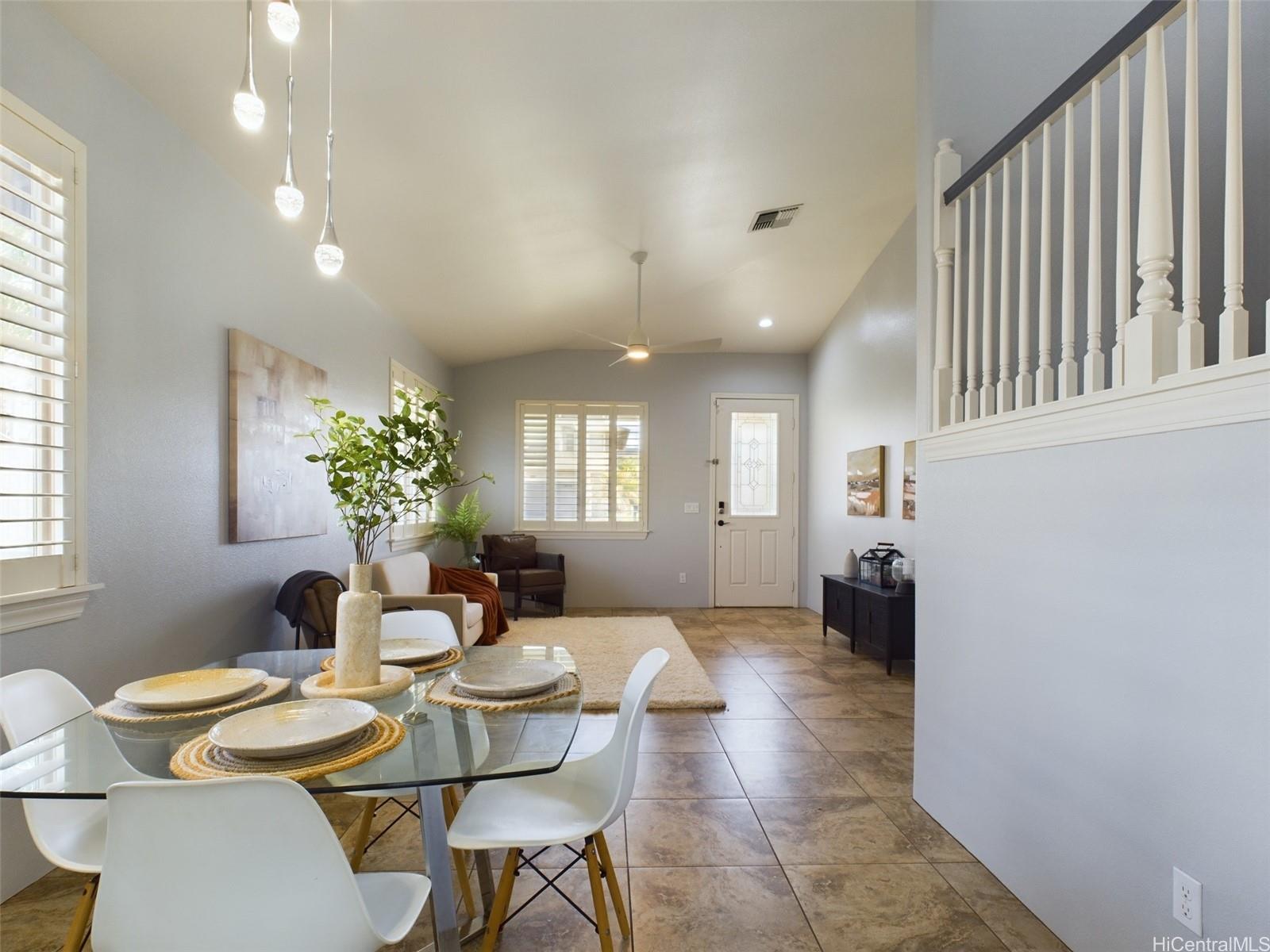 a dining room with furniture and a chandelier