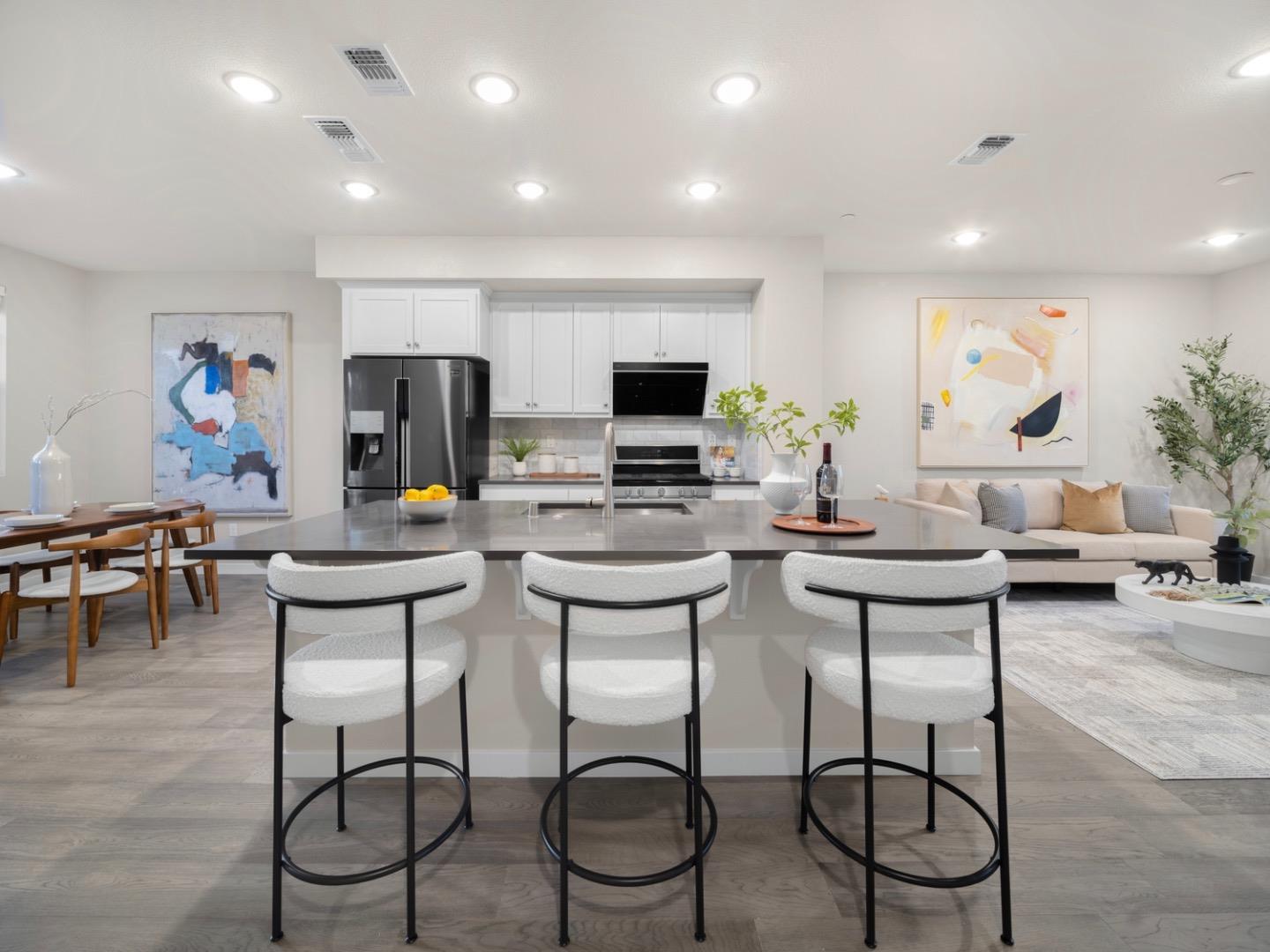 a view of a dining room with furniture and a flat screen tv