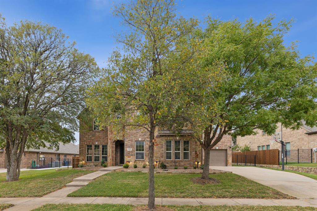 front view of a building with a tree