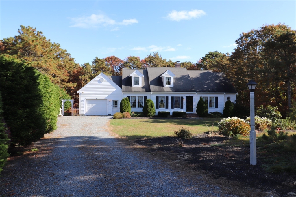 a view of a house with swimming pool next to a yard