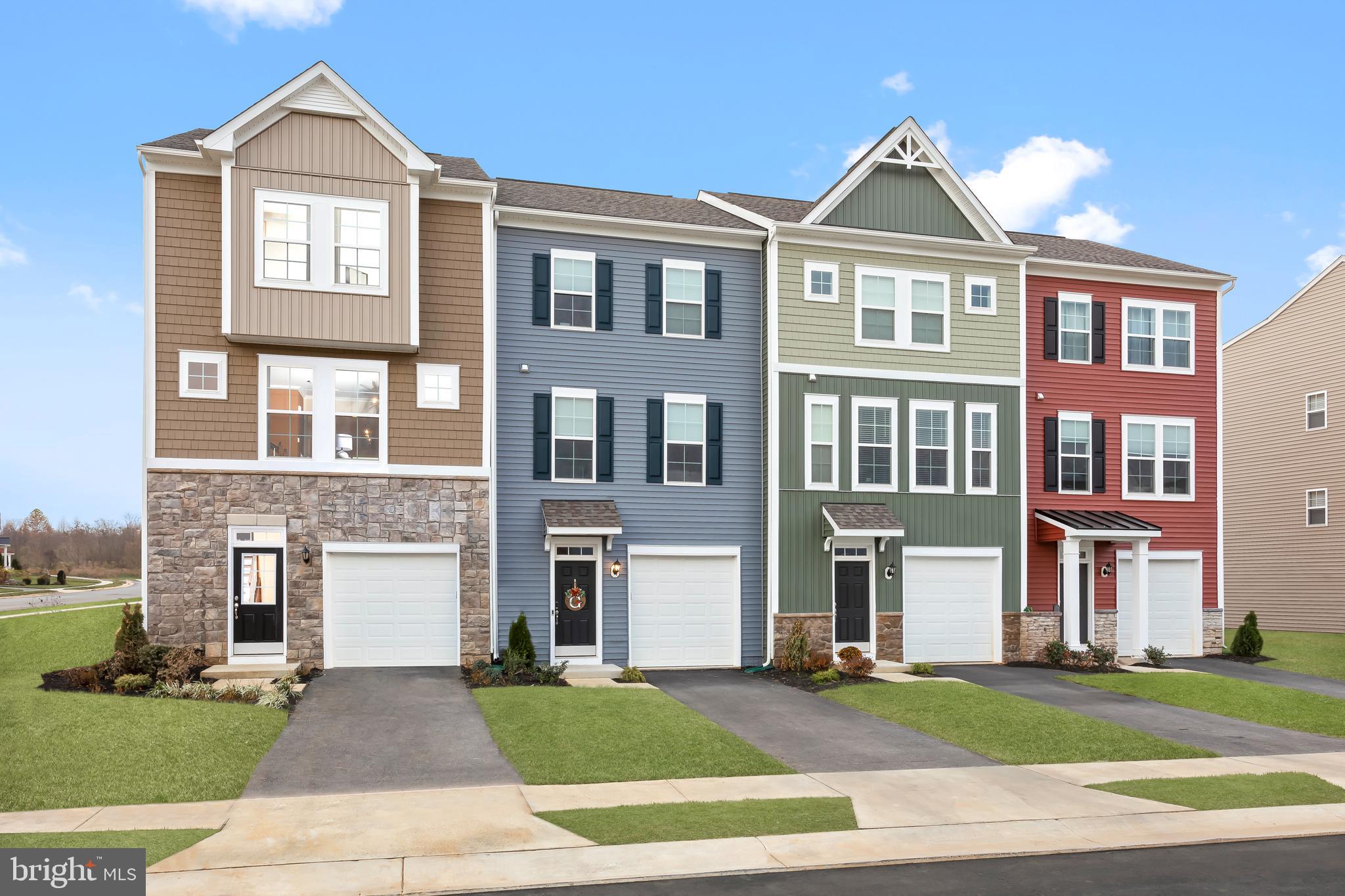 a front view of a residential apartment building with a yard