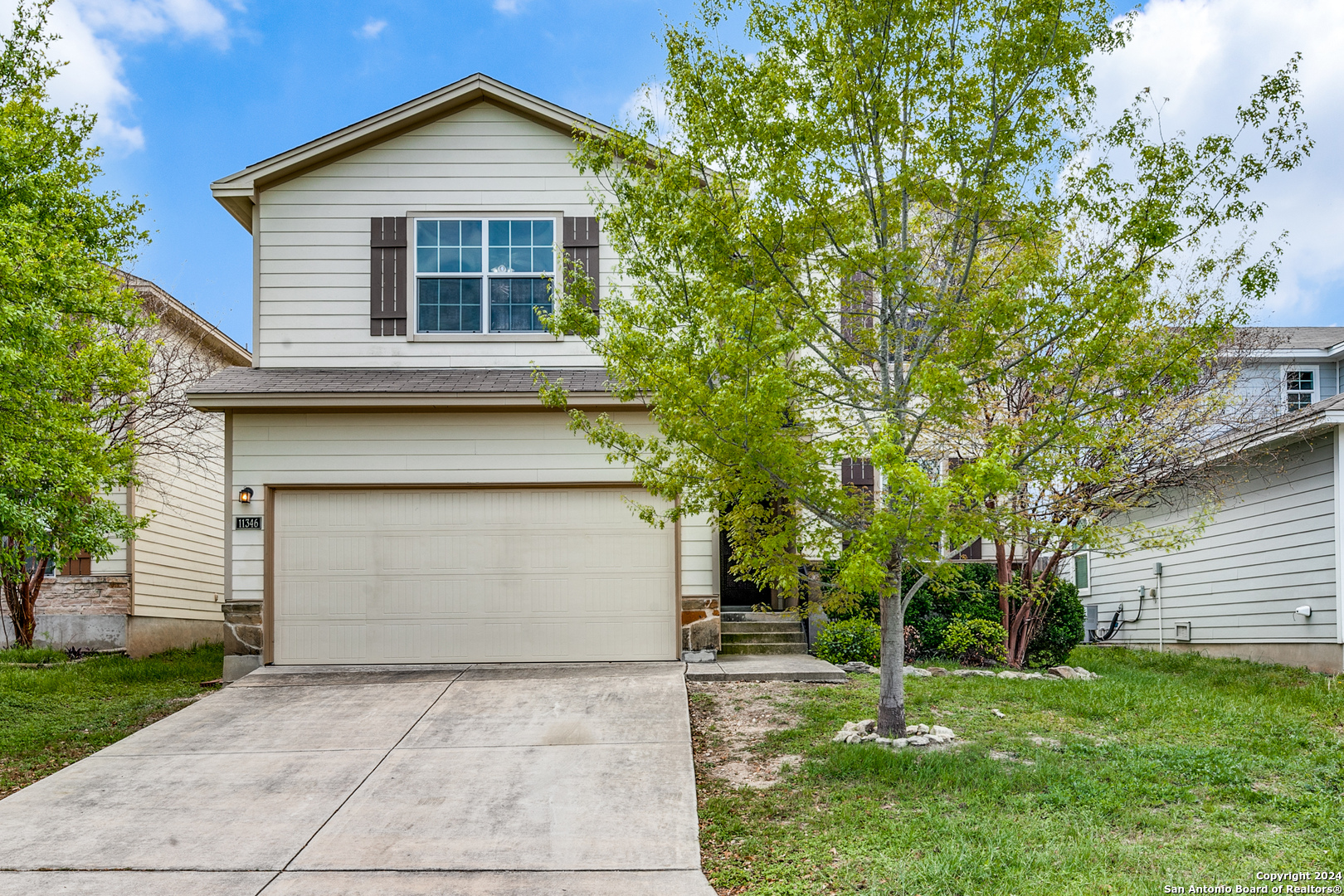 a front view of a house with a yard and garage