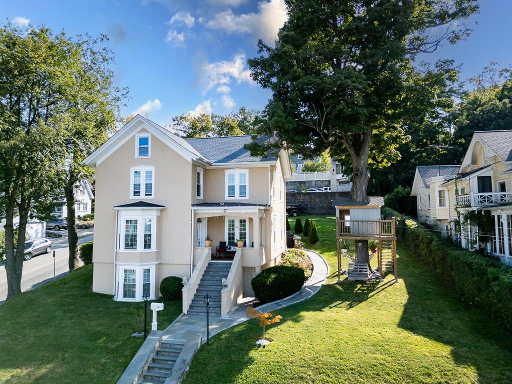 View of front of house with a front lawn and covered porch