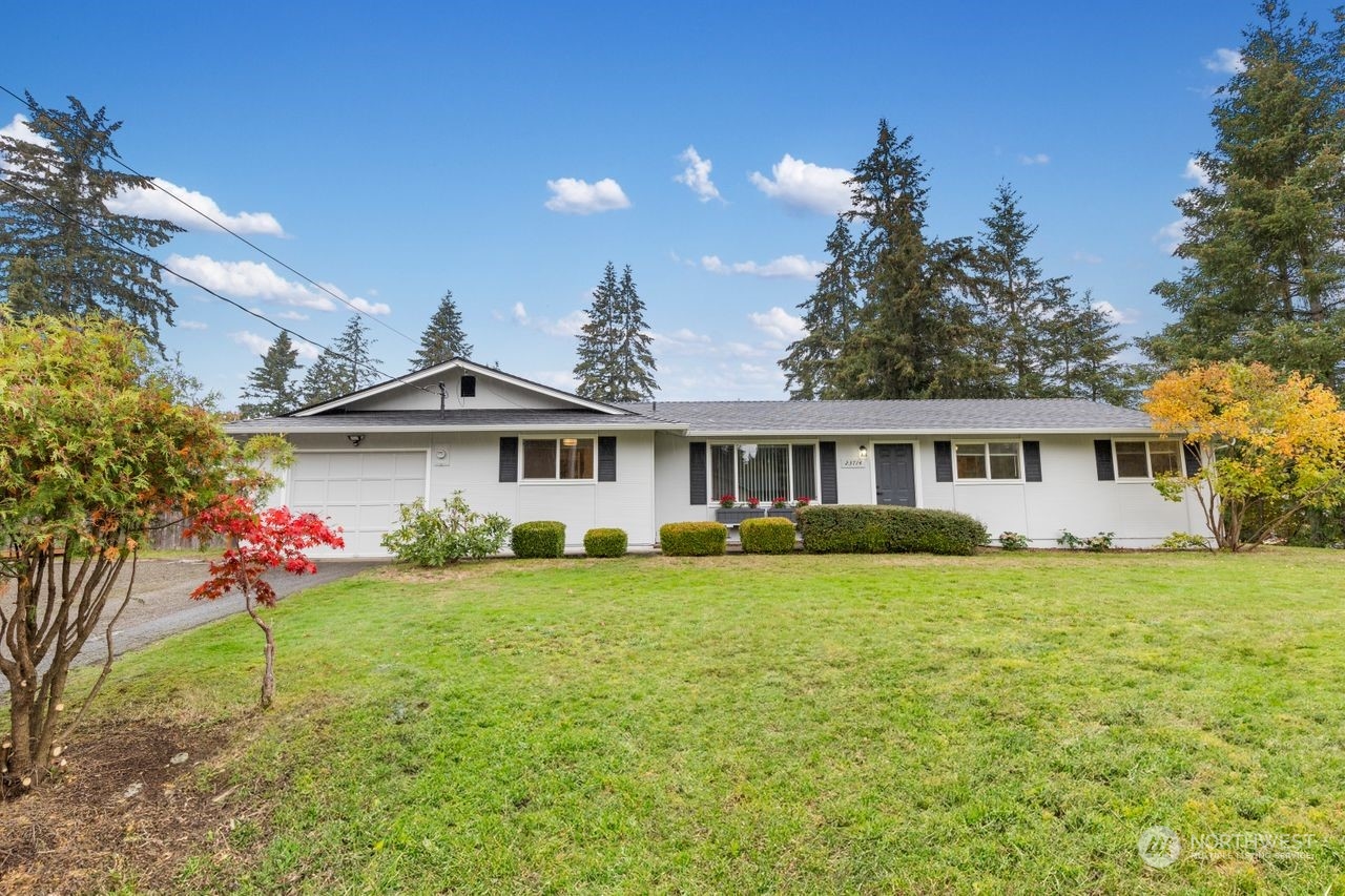 a front view of a house with a garden