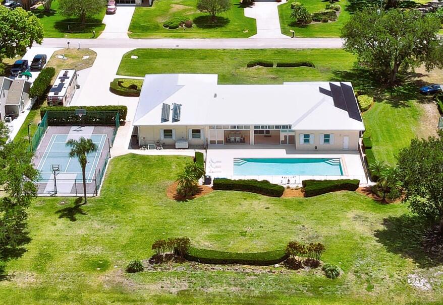 an aerial view of residential houses with outdoor space and swimming pool