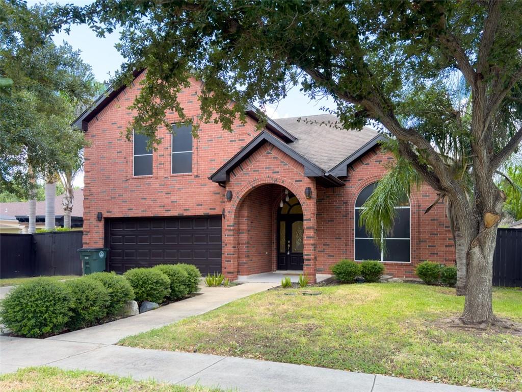 View of front of home featuring a garage and a front yard